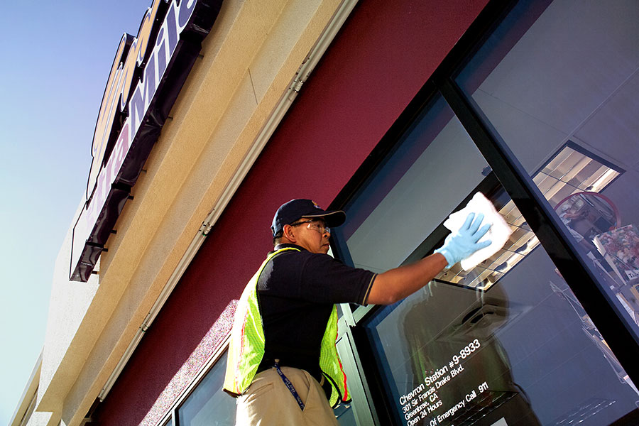 Yas Marina worker disinfecting retail store entry-way